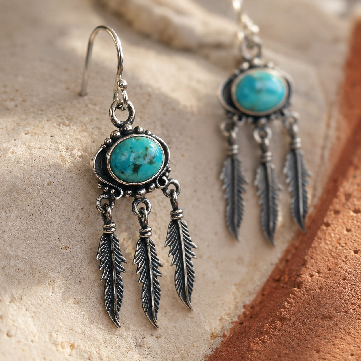 SOWELL JEWELRY Abey earrings featuring oval natural turquoise stones and articulated sterling silver feather fringe.