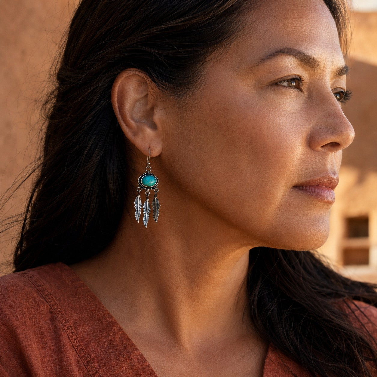 SOWELL JEWELRY Abey earrings featuring oval turquoise stones and sterling silver feather fringe on a woman