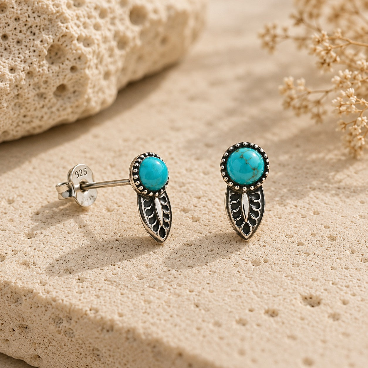 SOWELL JEWELRY Angelica turquoise earrings featuring round stones set in sterling silver leaf designs on stone.
