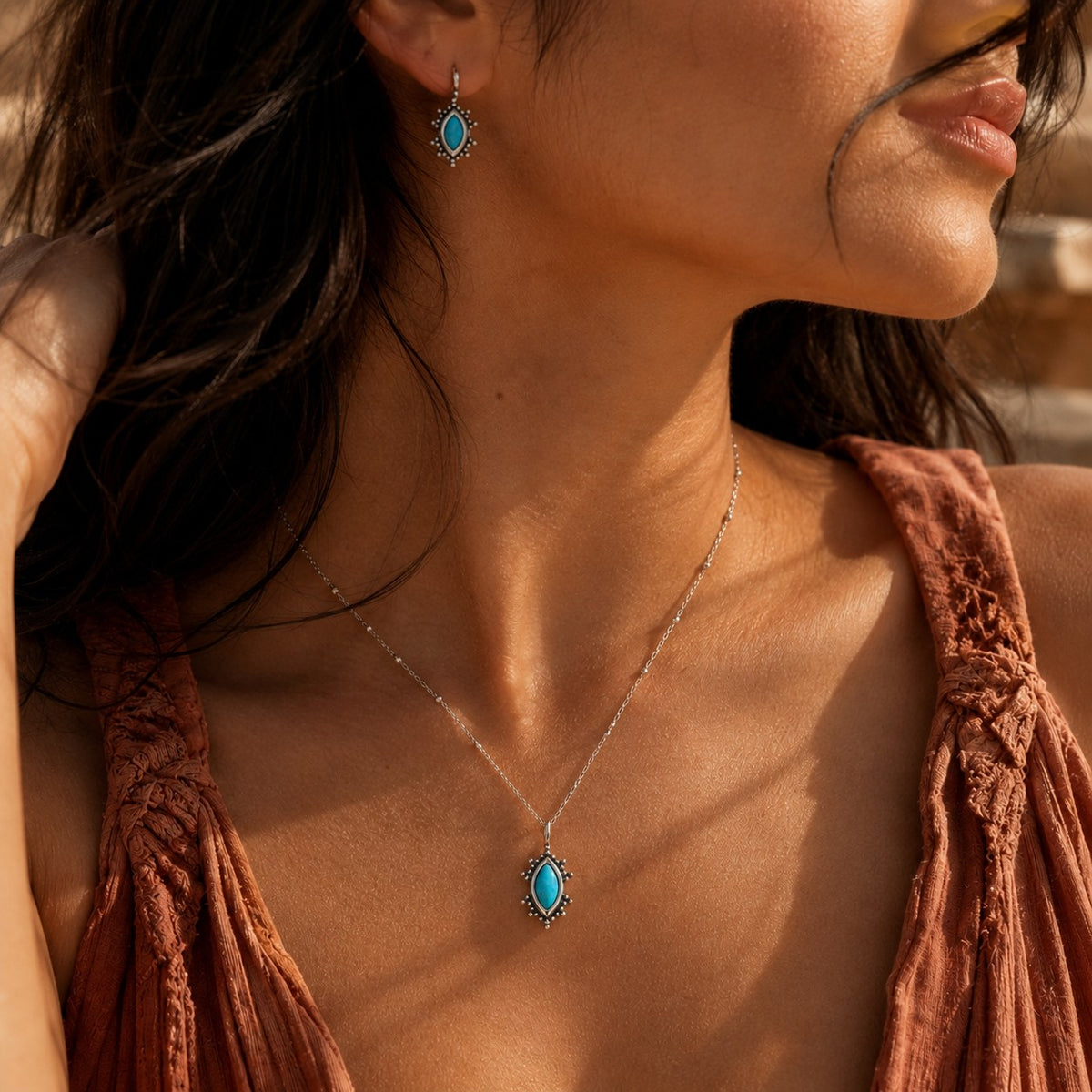SOWELL JEWELRY Kal turquoise pendant necklace and matching earring on a model in a boho style