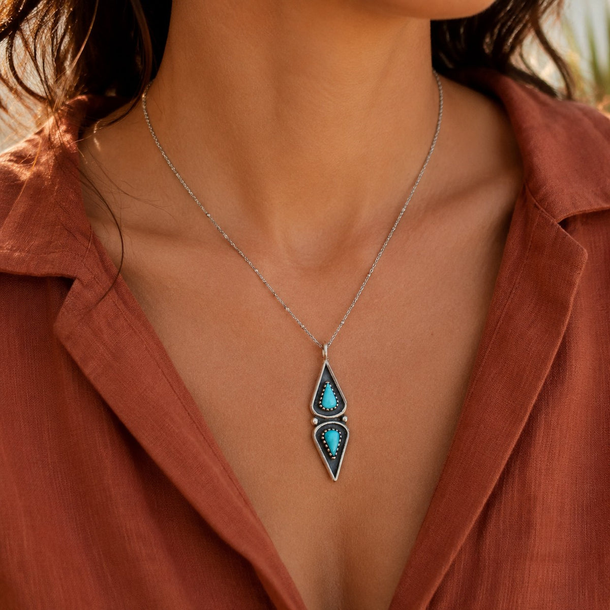 SOWELL JEWELRY turquoise pendant necklace featuring two elongated stones set in sterling silver on a delicate chain.
