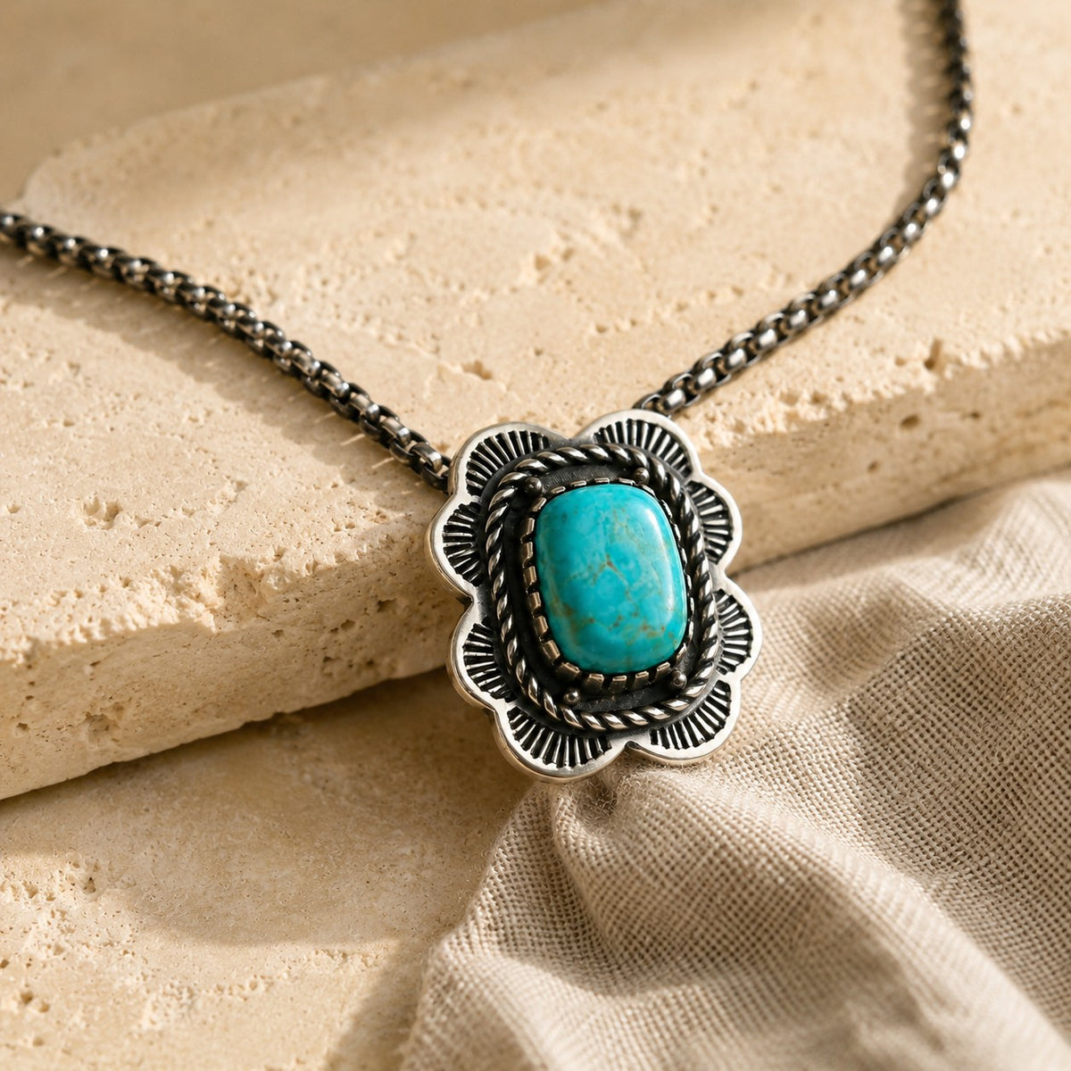 SOWELL JEWELRY Asia necklace featuring a cushion-shaped turquoise stone in a sterling silver floral setting.