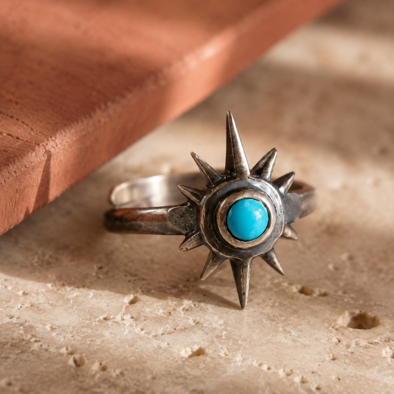 SOWELL JEWELRY sterling silver star ring featuring a round turquoise stone on an adjustable band