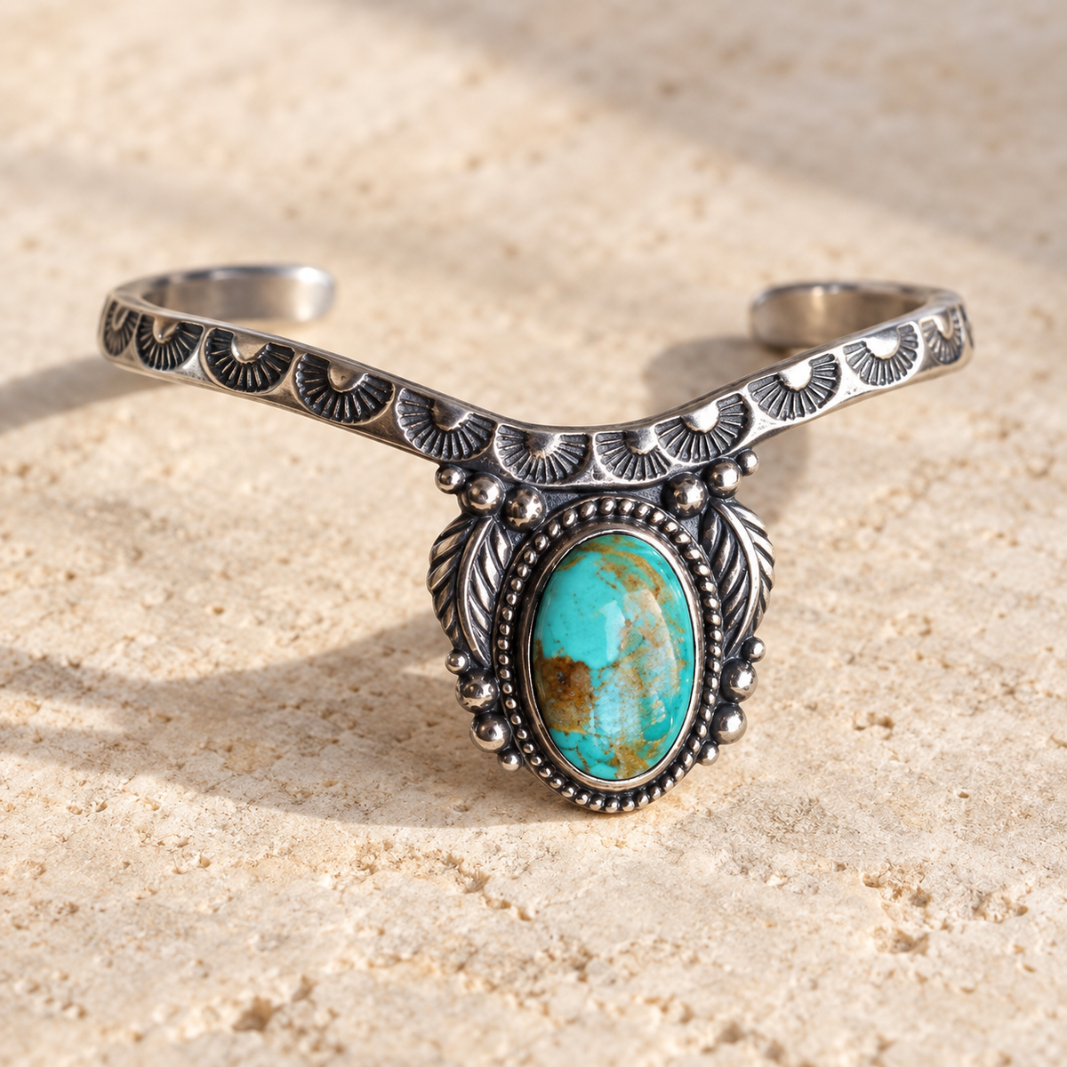 SOWELL JEWELRY Abai cuff bracelet featuring a large oval turquoise stone set in stamped sterling silver.