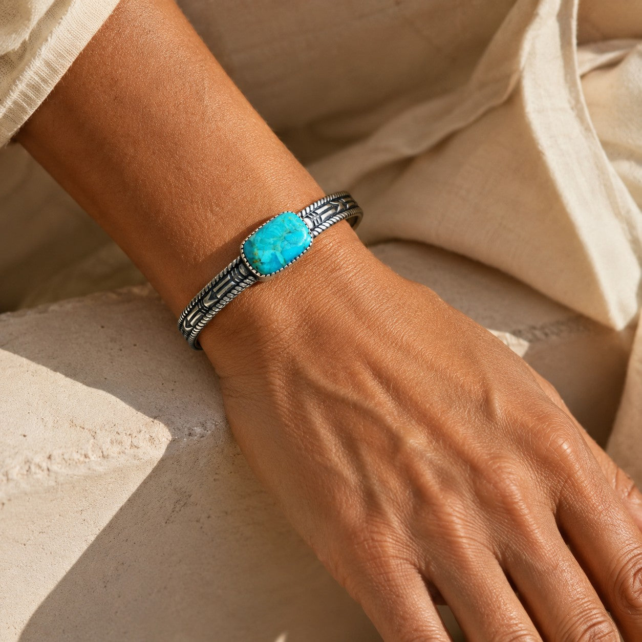 SOWELL JEWELRY Abha turquoise cuff bracelet in sterling silver with intricate southwestern detailing on a wrist