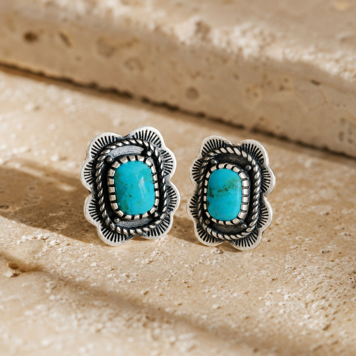SOWELL JEWELRY Asia earrings featuring cushion-shaped turquoise stones set in ornate sterling silver on stone surface