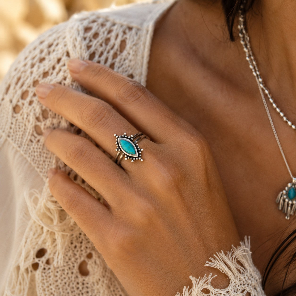 SOWELL JEWELRY Kal turquoise ring in a handcrafted sterling silver setting worn on a finger with boho attire.