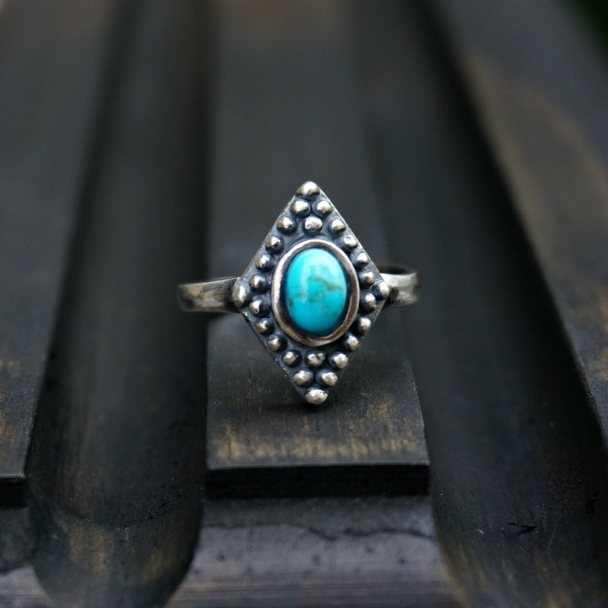 SOWELL JEWELRY Bahman ring featuring an oval turquoise stone set in a decorative sterling silver diamond-shaped band.