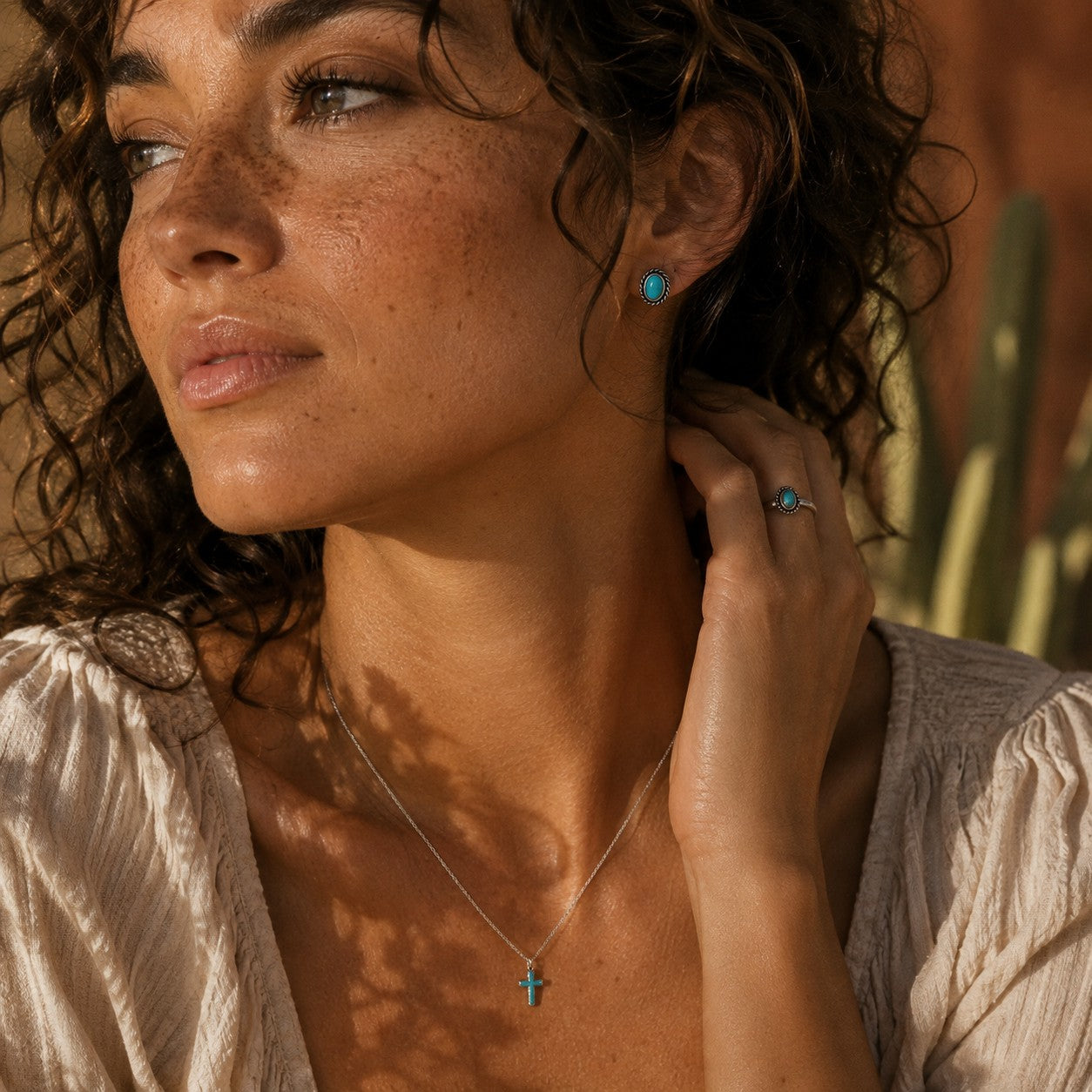 SOWELL JEWELRY Fala turquoise stud earrings in sterling silver worn by a woman in a southwestern boho setting