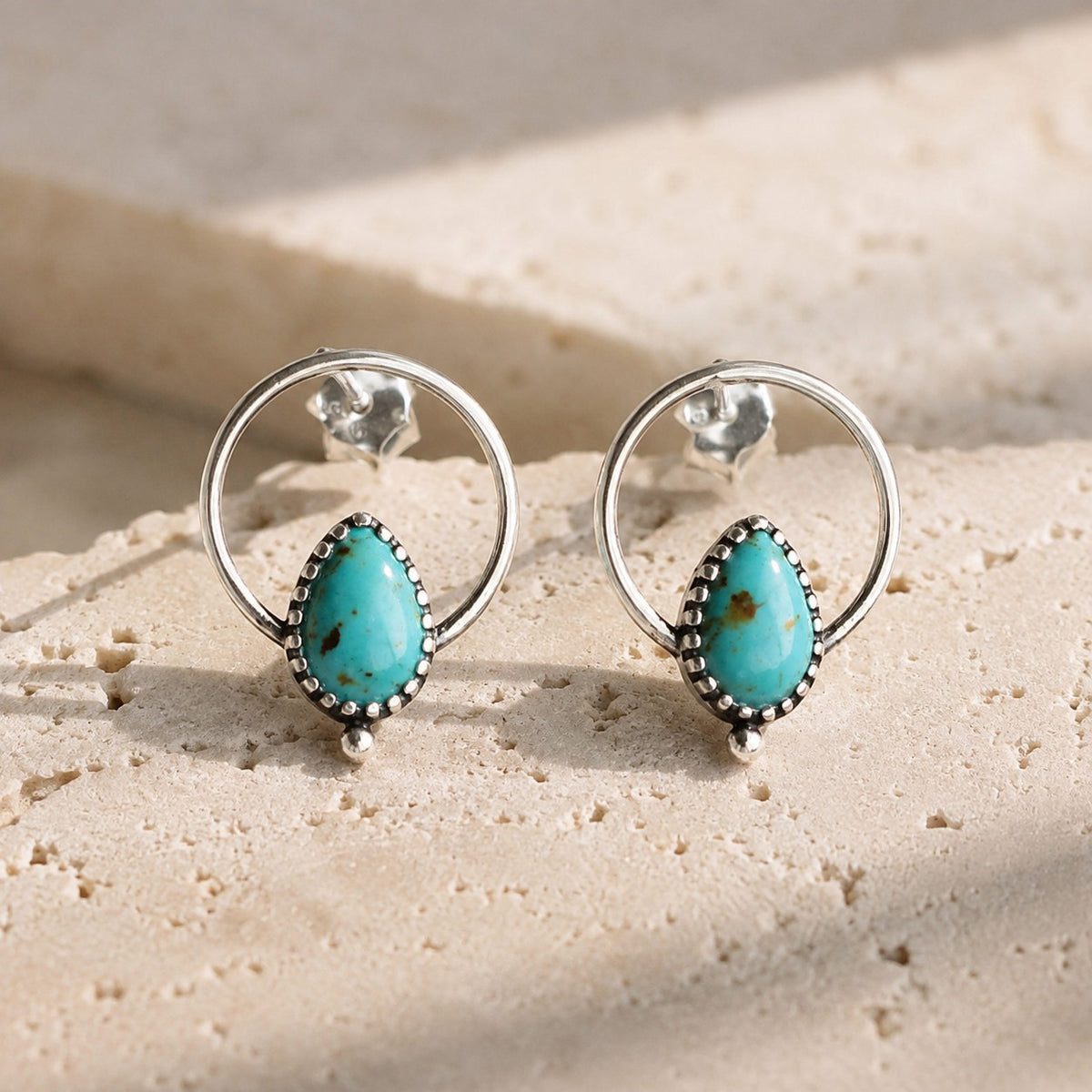 SOWELL JEWELRY Vale hoop earrings featuring teardrop compressed turquoise stones in handcrafted .925 sterling silver.