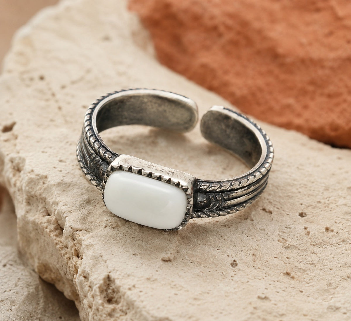 SOWELL JEWELRY adjustable sterling silver ring featuring a smooth white agate stone on an arrow-inspired band.