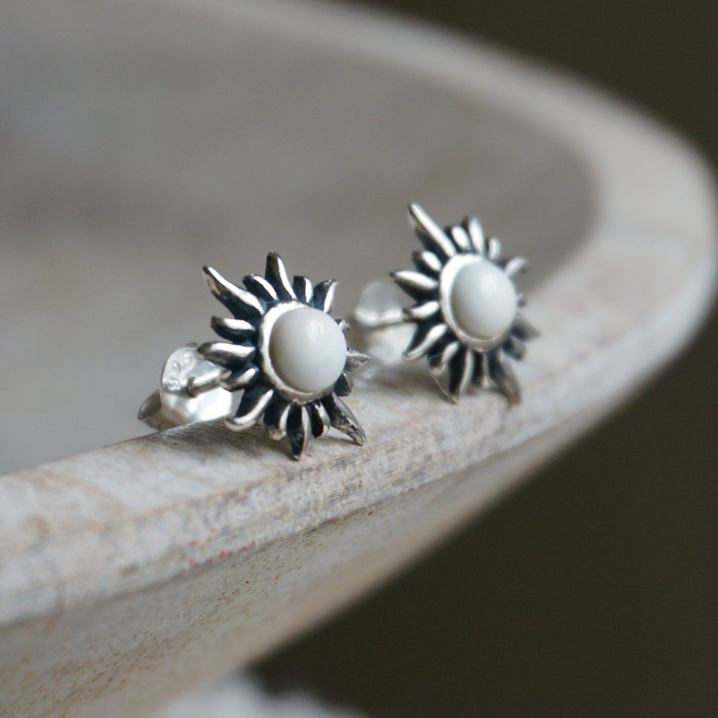 SOWELL JEWELRY white agate stud earrings featuring a handcrafted sterling silver sunburst design.