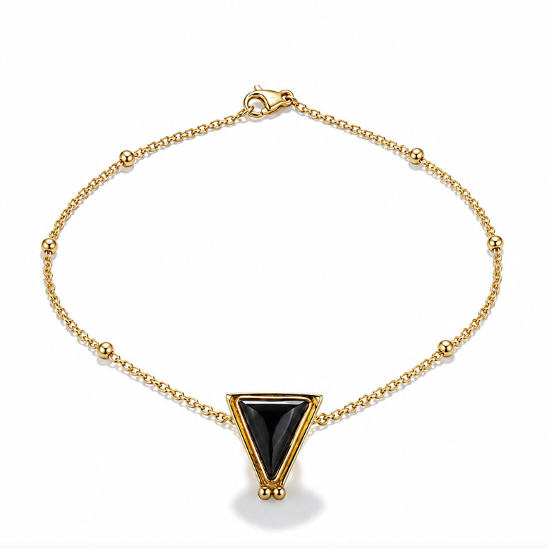 A gold chain necklace with a central triangular pendant featuring a black onyx inlay, by Sowell jewelry